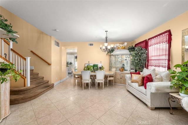 dining space featuring a notable chandelier and light tile patterned floors