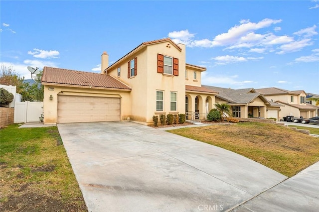 mediterranean / spanish house with a garage and a front yard