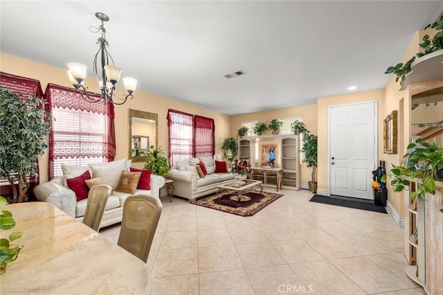 living room featuring plenty of natural light, light tile patterned floors, and a chandelier