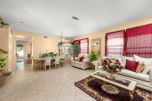 living room with light tile patterned floors and an inviting chandelier