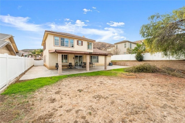 back of property with a patio area