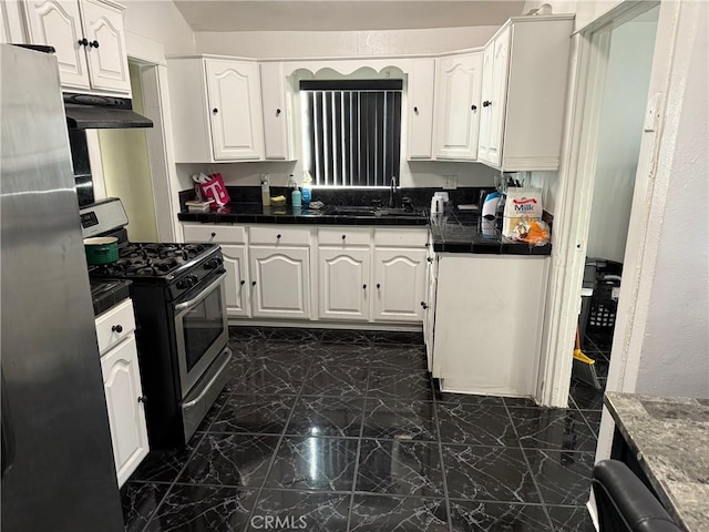 kitchen with stainless steel appliances, sink, and white cabinets