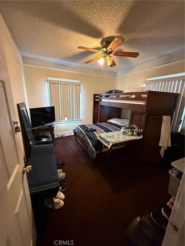 carpeted bedroom with ornamental molding and a textured ceiling