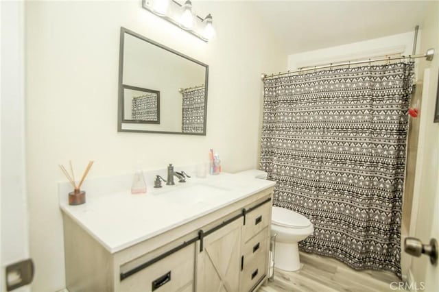 bathroom with a shower with curtain, vanity, toilet, and hardwood / wood-style floors