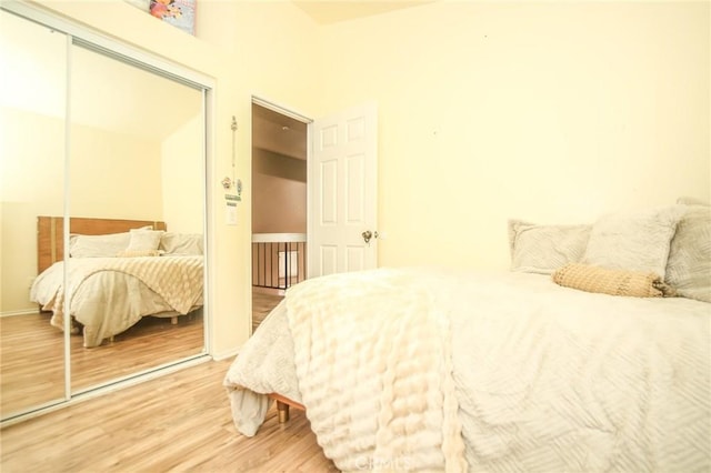 bedroom with hardwood / wood-style floors and a closet