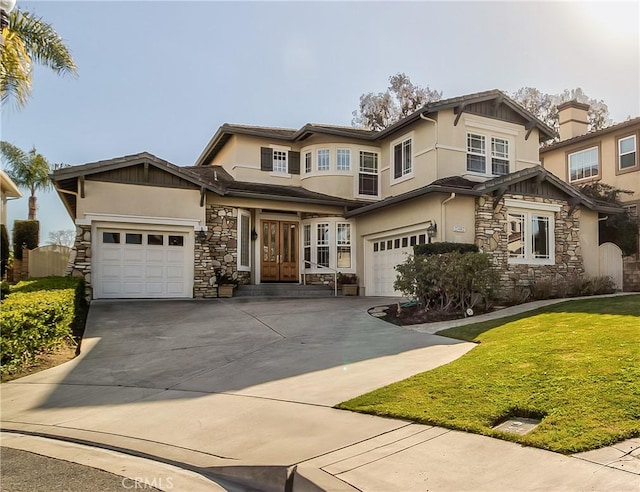 view of front facade featuring a garage and a front lawn