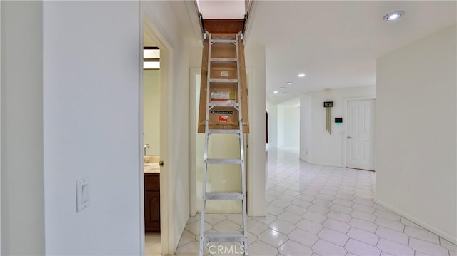 hallway with baseboards and recessed lighting