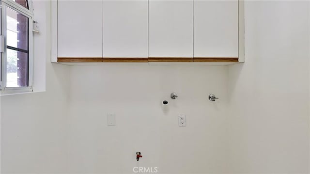 clothes washing area featuring cabinet space