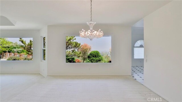 spare room featuring a notable chandelier