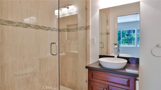 full bath with a shower stall and vanity