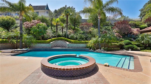 view of swimming pool with a diving board and an in ground hot tub