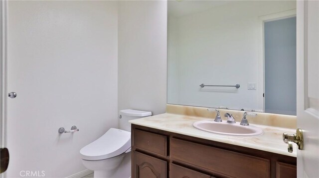 bathroom with vanity and toilet