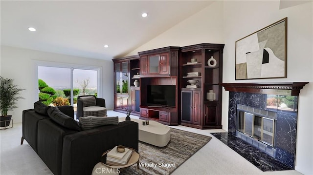 living room featuring vaulted ceiling, carpet, a high end fireplace, and recessed lighting