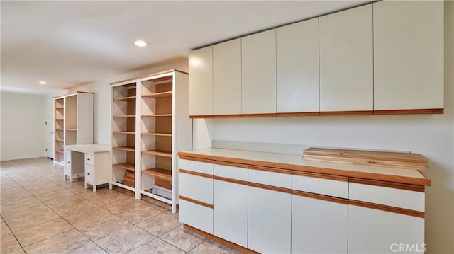 interior space featuring light tile patterned floors and recessed lighting