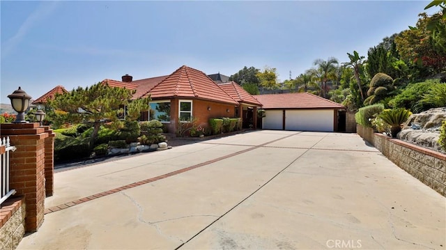 mediterranean / spanish home with a garage