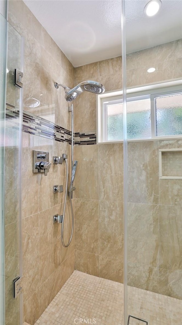 bathroom with a shower stall