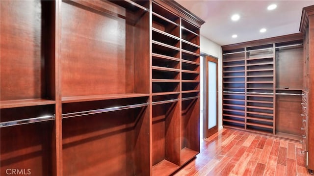 walk in closet featuring wood finished floors