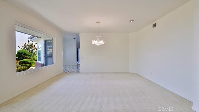 unfurnished room featuring light carpet and a notable chandelier