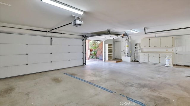 garage featuring a garage door opener and water heater