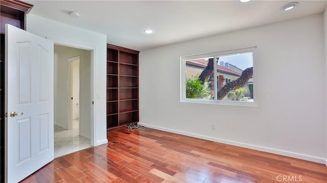 spare room featuring hardwood / wood-style flooring