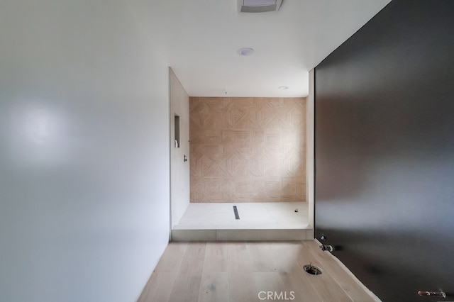 bathroom with wood-type flooring and a shower