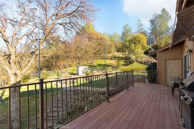 wooden terrace with a yard