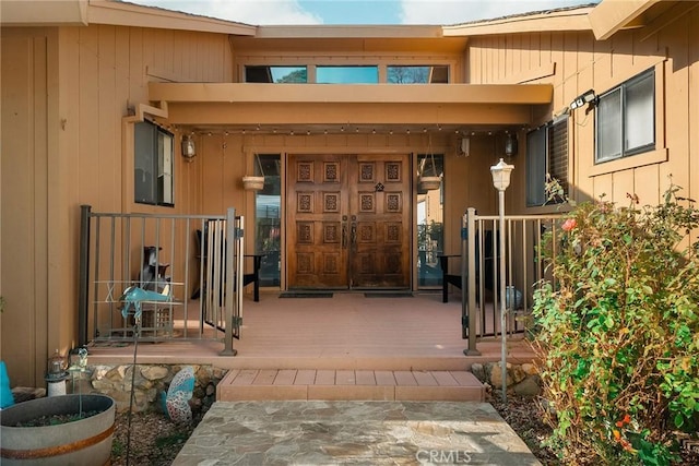 view of exterior entry with covered porch