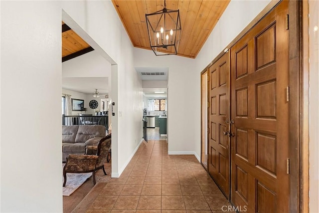 hallway featuring light tile patterned floors, a wealth of natural light, wooden ceiling, and vaulted ceiling