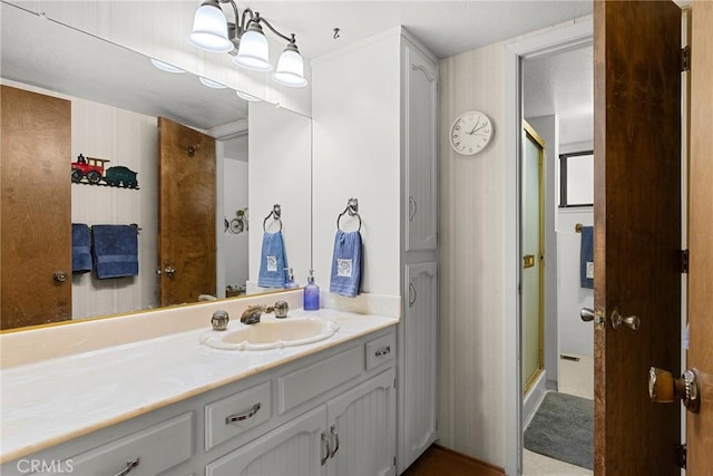 bathroom featuring vanity and an enclosed shower