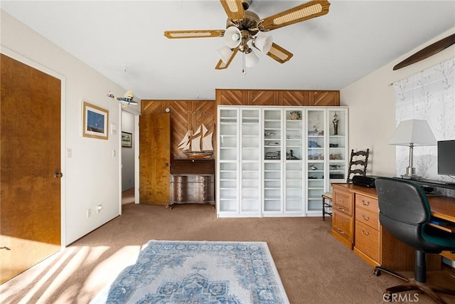 carpeted home office with ceiling fan