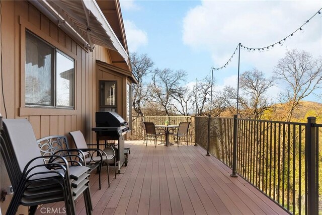 wooden terrace with area for grilling