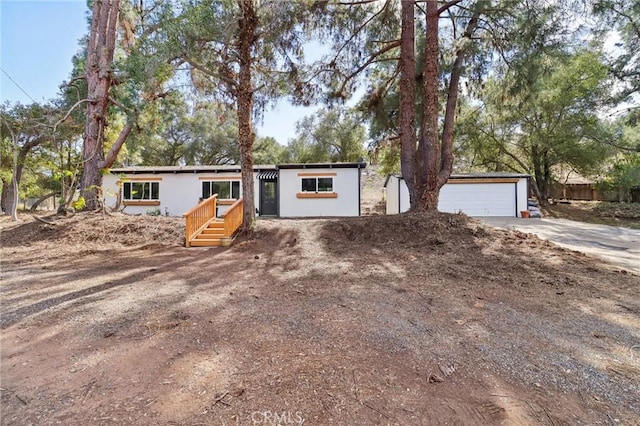 view of front of home featuring a garage and an outdoor structure