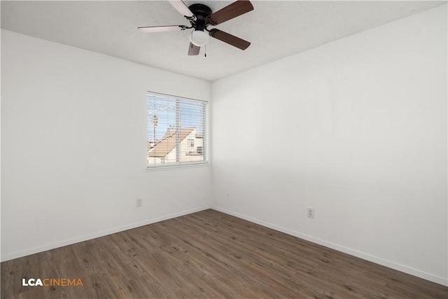 spare room featuring ceiling fan and dark hardwood / wood-style flooring