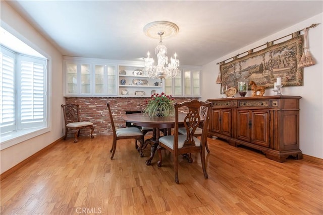 dining space featuring light hardwood / wood-style floors and a chandelier