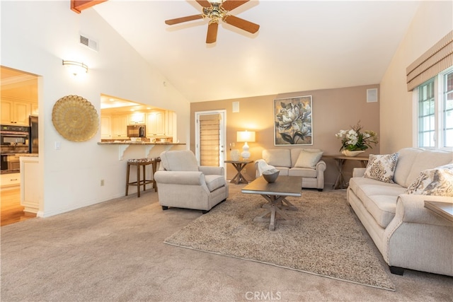 living room featuring beam ceiling, ceiling fan, light colored carpet, and high vaulted ceiling