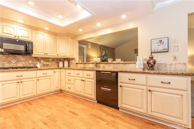 kitchen featuring sink, light hardwood / wood-style flooring, light stone countertops, black appliances, and kitchen peninsula