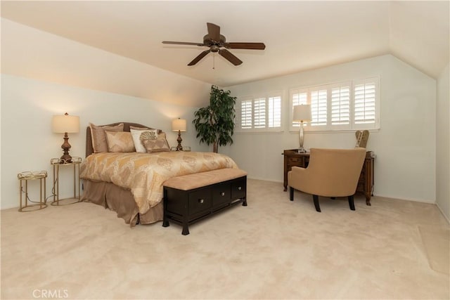 bedroom with vaulted ceiling, ceiling fan, and carpet flooring