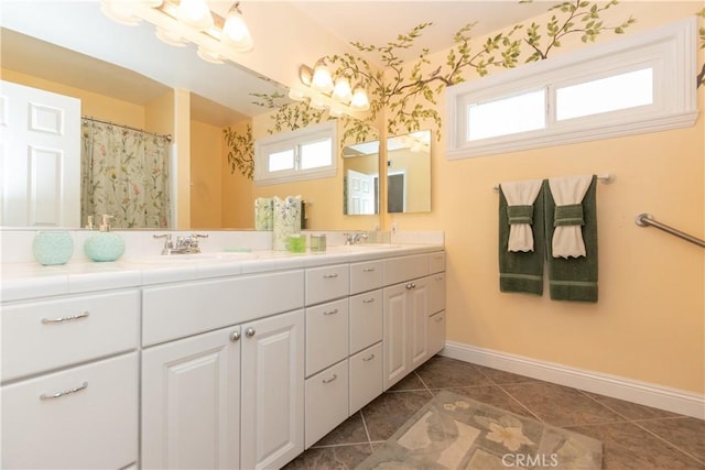 bathroom featuring a healthy amount of sunlight, curtained shower, and vanity