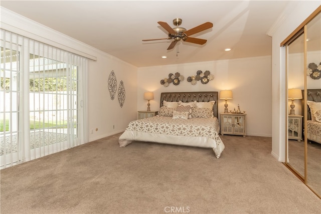 bedroom with carpet floors, ornamental molding, a closet, and ceiling fan