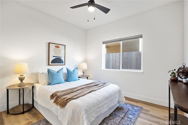 bedroom with ceiling fan and light hardwood / wood-style flooring