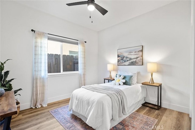 bedroom with light hardwood / wood-style floors and ceiling fan