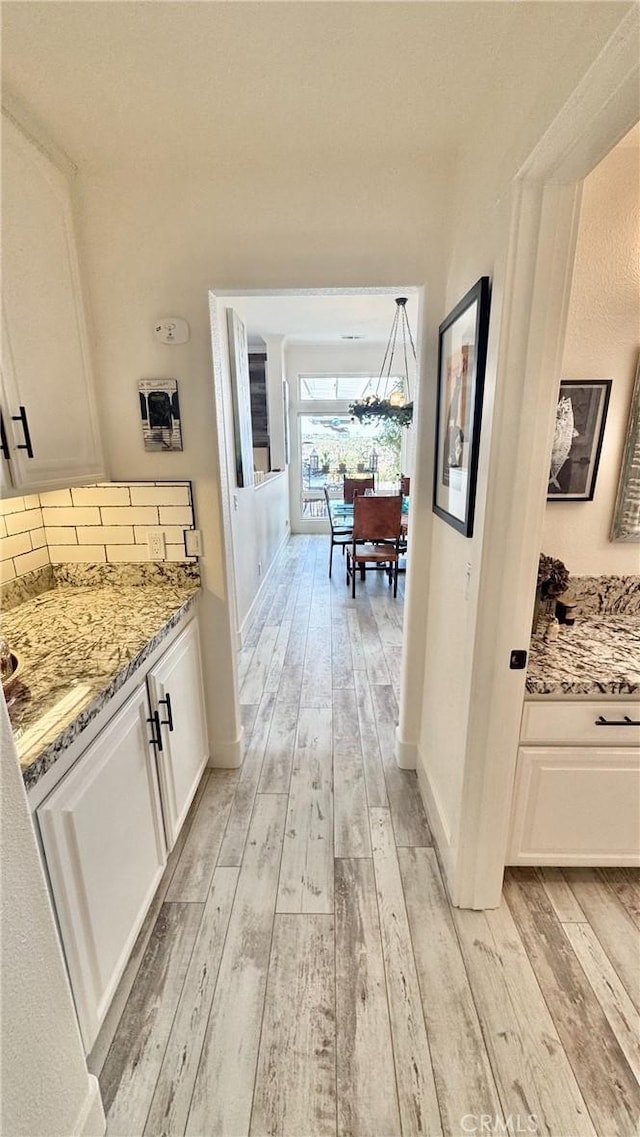 corridor featuring light hardwood / wood-style flooring