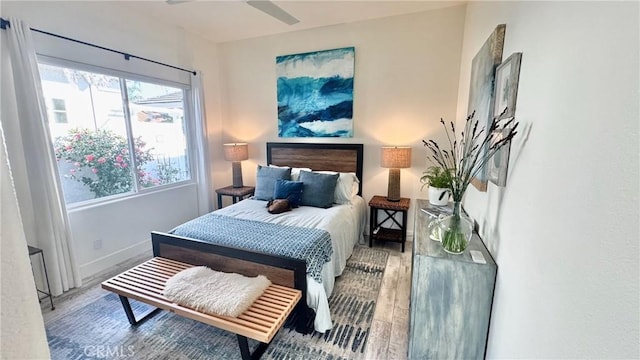 bedroom with hardwood / wood-style flooring and ceiling fan