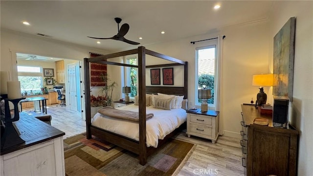 bedroom featuring multiple windows and light hardwood / wood-style flooring