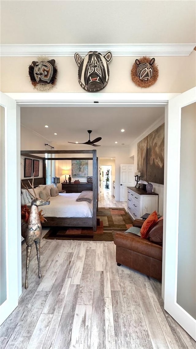 bedroom featuring ornamental molding and light hardwood / wood-style floors