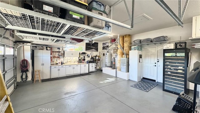 garage with strapped water heater and a workshop area