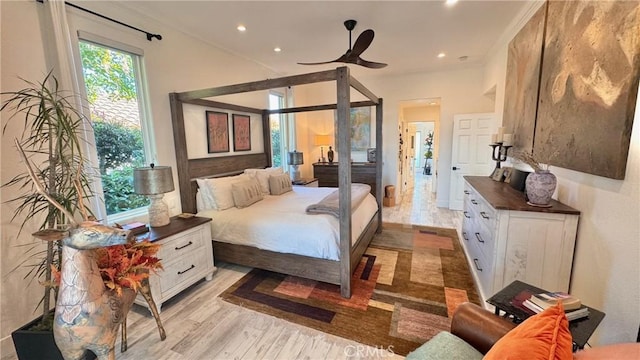 bedroom with crown molding and light hardwood / wood-style flooring