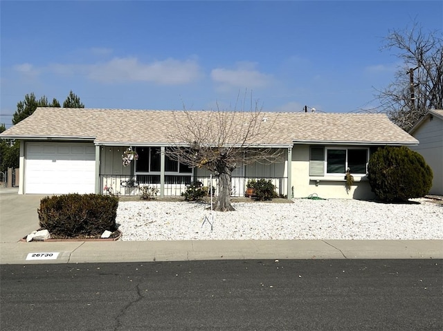 single story home featuring a garage and a porch