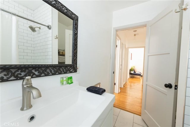 bathroom featuring tile patterned flooring, sink, and a shower with curtain