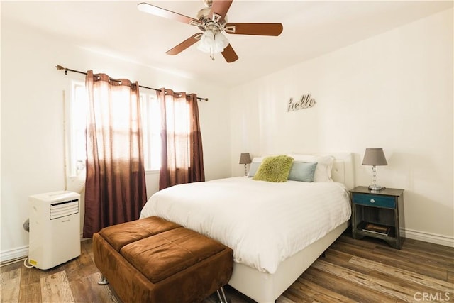 bedroom with ceiling fan and dark hardwood / wood-style flooring